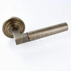 Tubular Pattern Lever Handles With Stepped Round Rose - Suitable For Use With FD30 / FD60 Fire Doors - Antique Brass (Lacquered)
