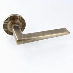 Wedge Pattern Lever Handles With Reeded Round Rose - Suitable For Use With FD30 / FD60 Fire Doors - Antique Brass (Lacquered)